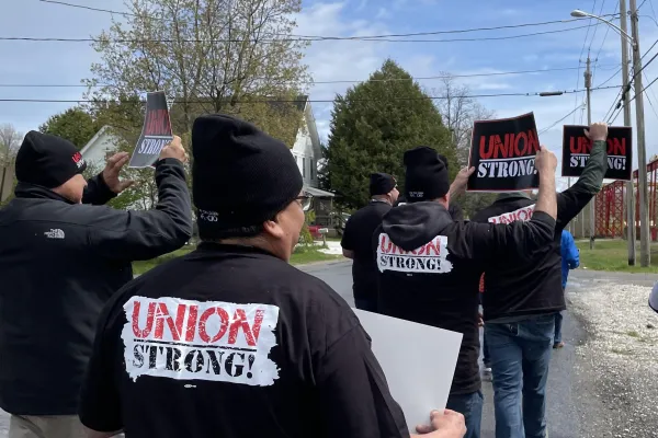 Workers wearing Union Strong shirts on a picket line