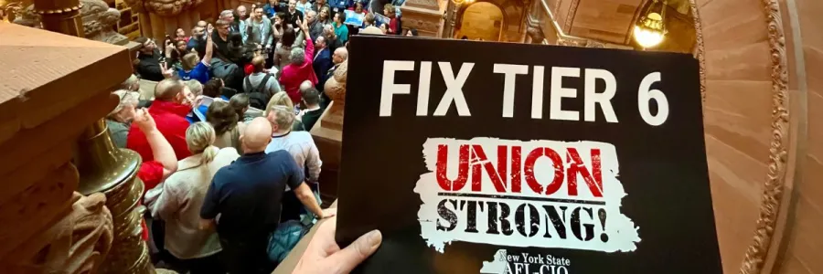 crowd at a tier 6 rally with a fix tier 6 sign in the foreground