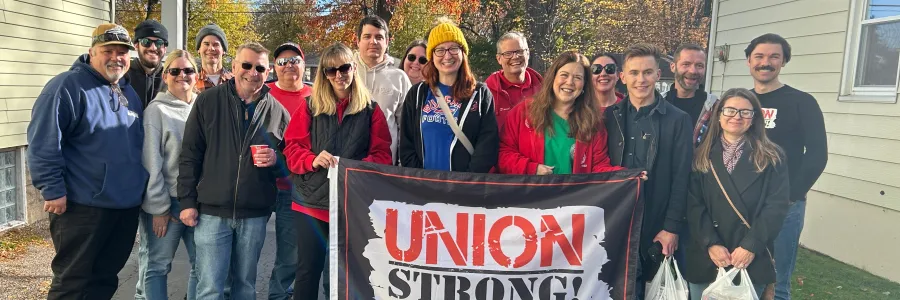 group of volunteers holding union strong flag