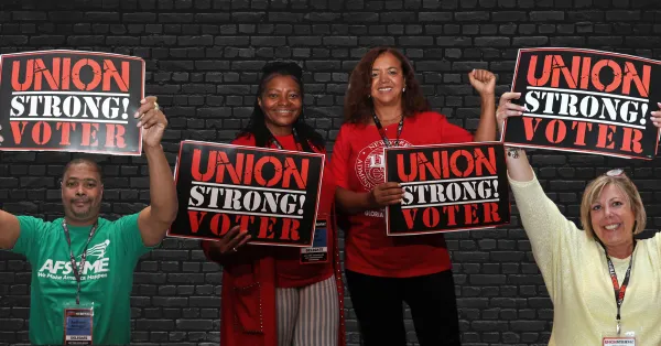People holding "union strong voter" signs
