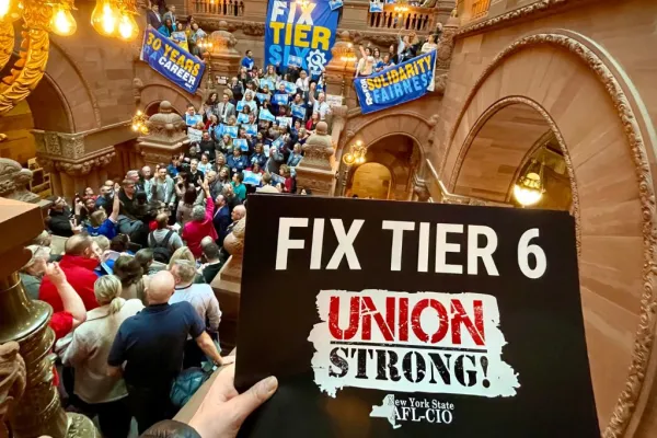 crowd at a tier 6 rally with a fix tier 6 sign in the foreground