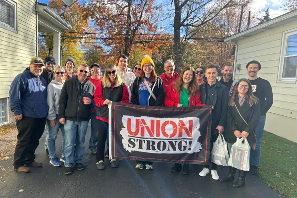 group of volunteers holding union strong flag
